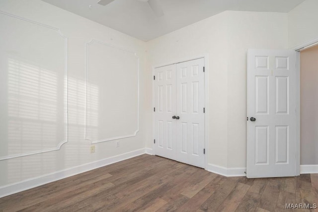 unfurnished room featuring dark hardwood / wood-style floors and ceiling fan