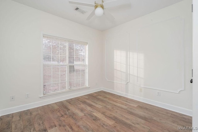 spare room featuring hardwood / wood-style flooring and ceiling fan