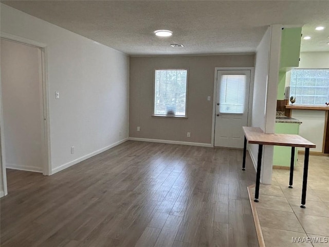 interior space with wood-type flooring and a textured ceiling