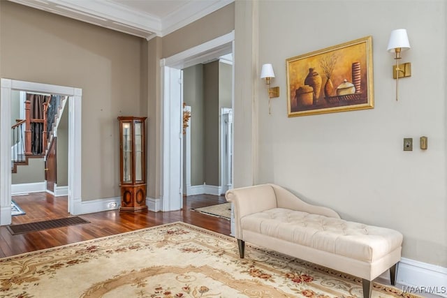 sitting room featuring dark wood-type flooring and ornamental molding