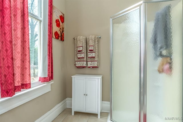 bathroom featuring tile patterned flooring and an enclosed shower