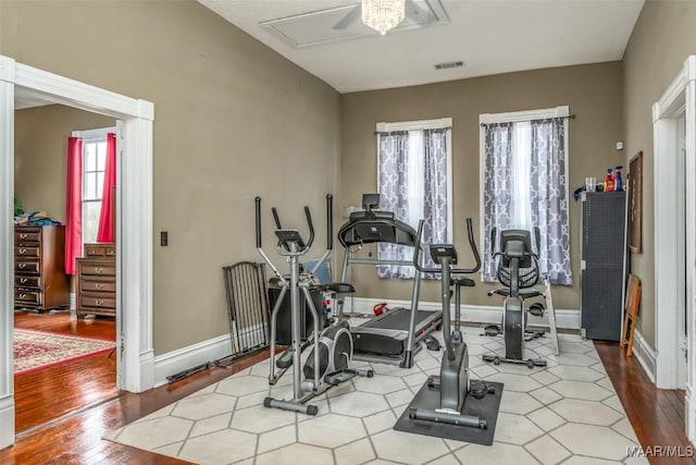 workout room with light hardwood / wood-style flooring