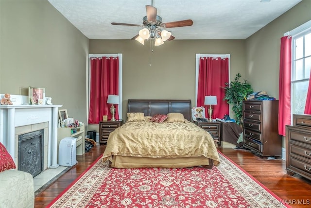 bedroom featuring ceiling fan, hardwood / wood-style flooring, and a textured ceiling