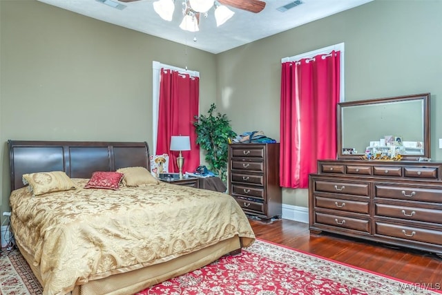 bedroom with dark hardwood / wood-style floors and ceiling fan