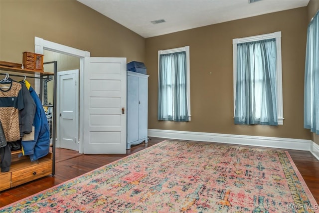 bedroom with lofted ceiling and dark wood-type flooring