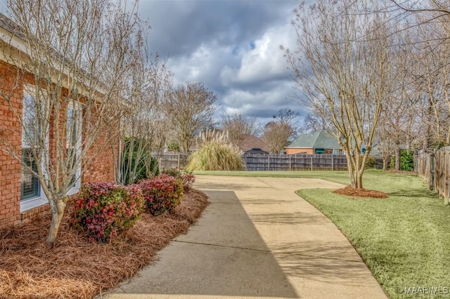 view of home's community with a patio area and a lawn