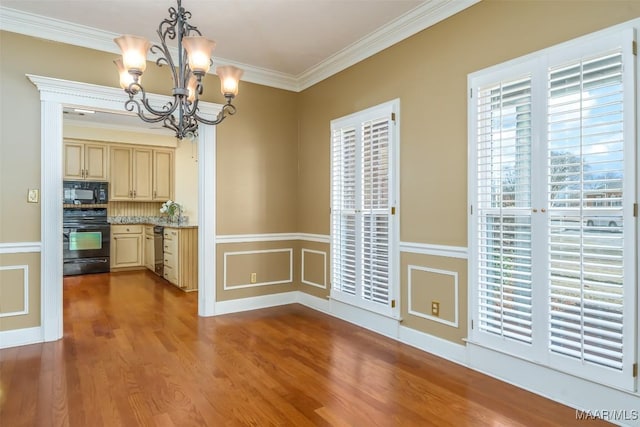 kitchen with crown molding, hardwood / wood-style flooring, hanging light fixtures, electric range, and stainless steel dishwasher