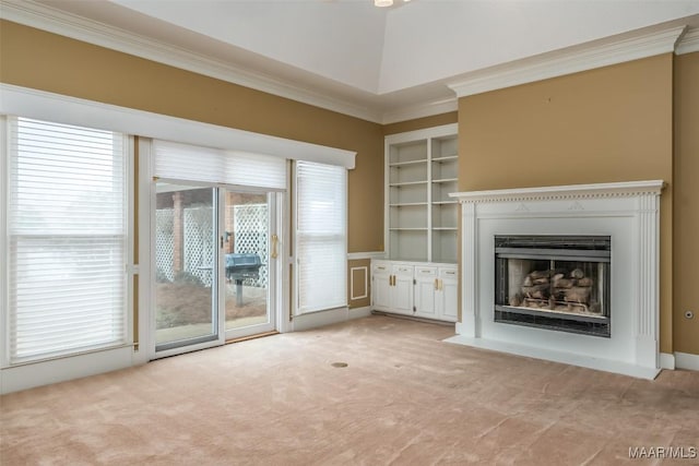 unfurnished living room with crown molding, light carpet, and built in features