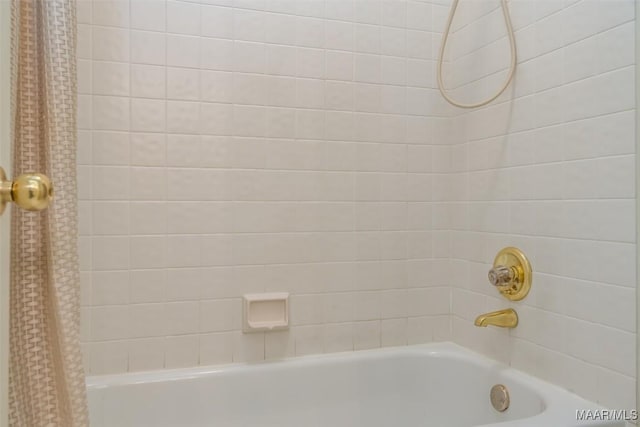 bathroom with shower / bath combo with shower curtain