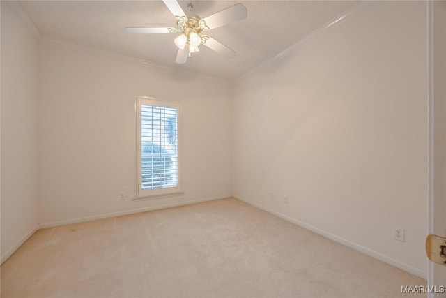 carpeted spare room featuring crown molding and ceiling fan