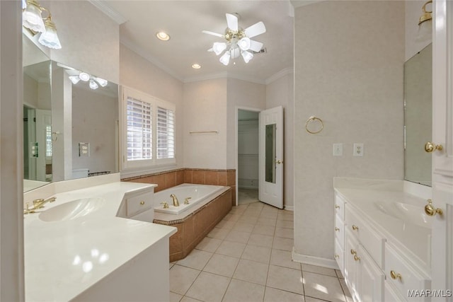 bathroom with crown molding, vanity, a relaxing tiled tub, ceiling fan, and tile patterned flooring