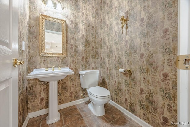 bathroom featuring tile patterned flooring and toilet