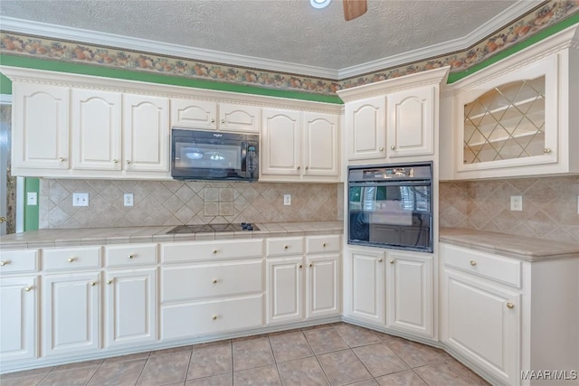 kitchen featuring ceiling fan, backsplash, black appliances, a textured ceiling, and light tile patterned flooring