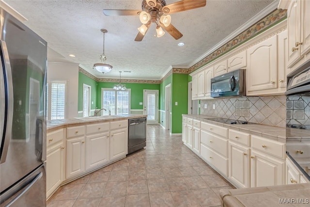 kitchen with pendant lighting, light tile patterned floors, plenty of natural light, and black appliances