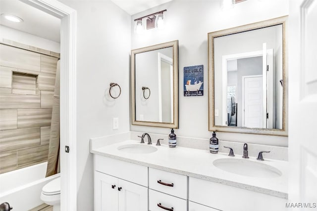 full bathroom with vanity, toilet, and tiled shower / bath combo