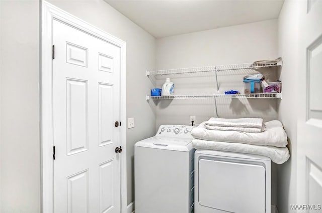 washroom featuring washing machine and clothes dryer