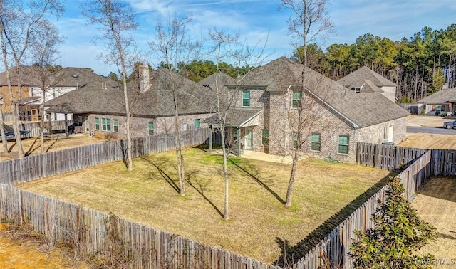 rear view of property featuring a lawn