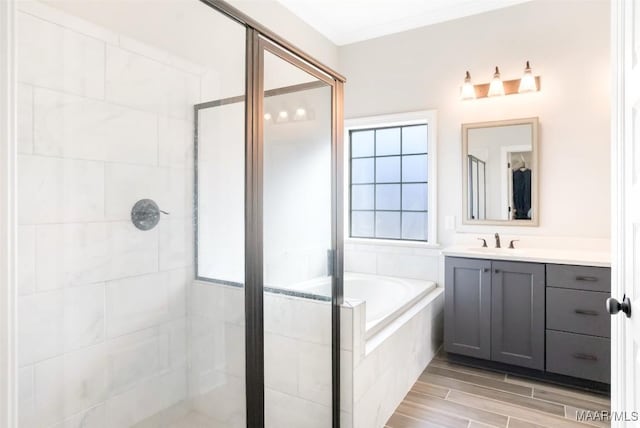 bathroom with crown molding, vanity, and separate shower and tub