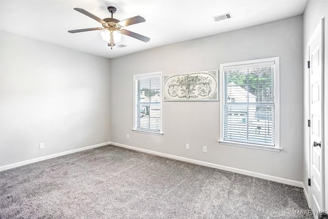 carpeted empty room featuring ceiling fan