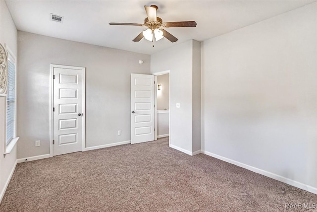 unfurnished bedroom with ceiling fan and carpet