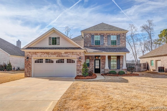 view of front of house featuring a garage, central AC unit, and a front lawn