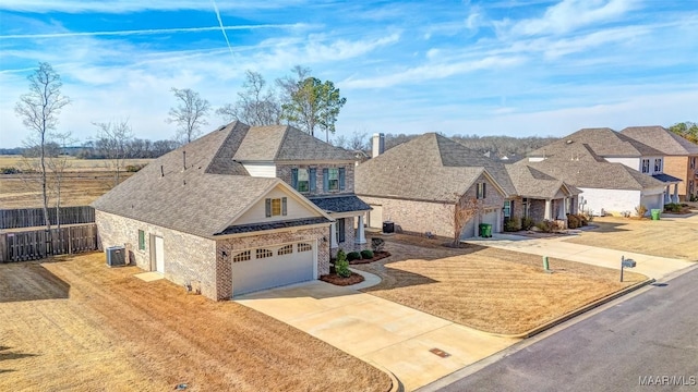 view of front facade featuring central AC, a garage, and a front lawn