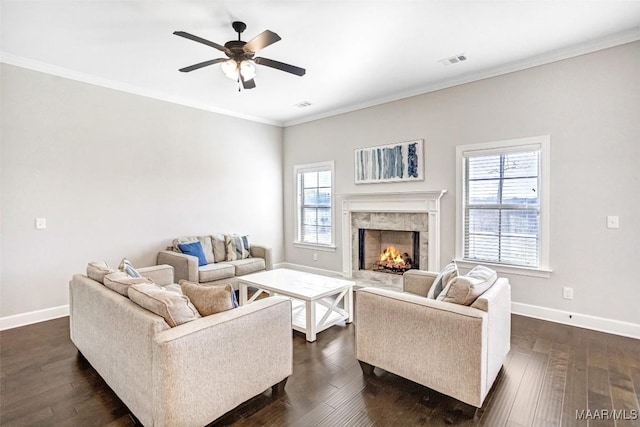 living room featuring crown molding, dark hardwood / wood-style floors, and a healthy amount of sunlight