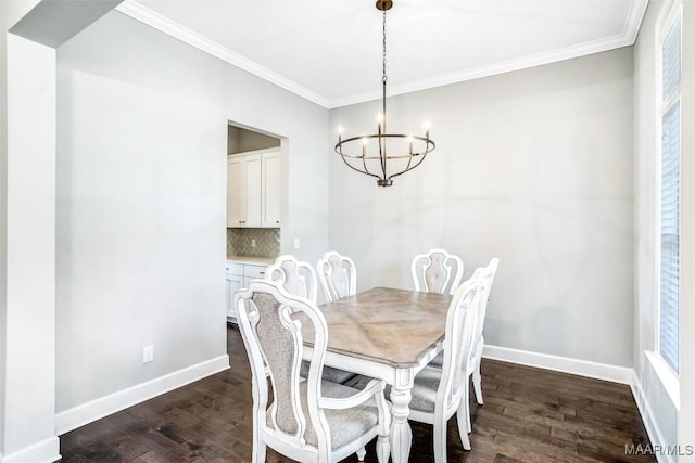 dining room with crown molding, dark hardwood / wood-style flooring, and an inviting chandelier