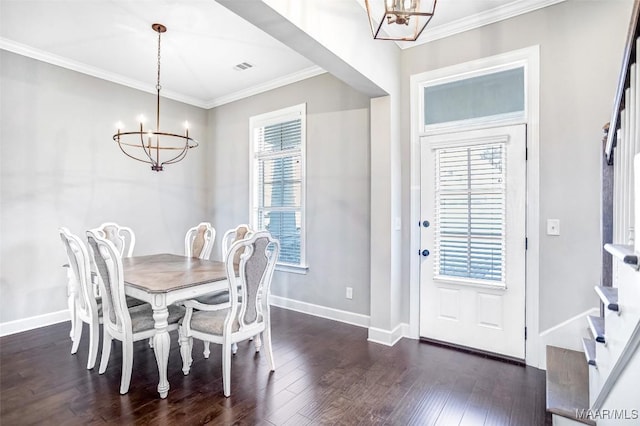 dining area with ornamental molding, dark wood-type flooring, and a notable chandelier