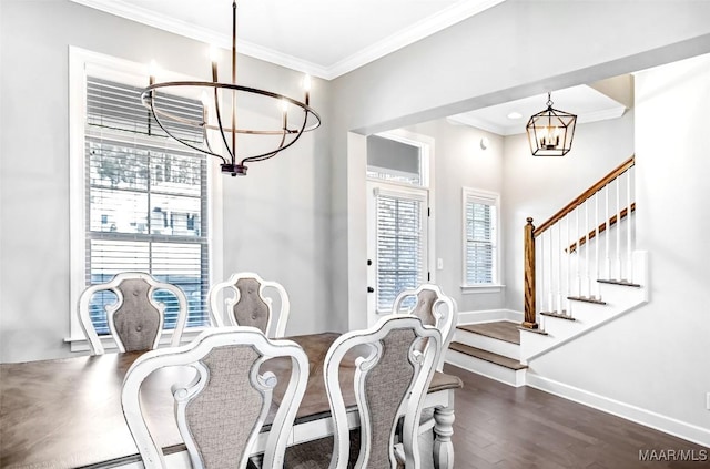 dining room featuring ornamental molding, dark wood-type flooring, and an inviting chandelier