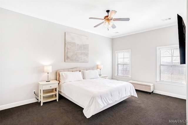 bedroom featuring multiple windows, crown molding, and dark carpet