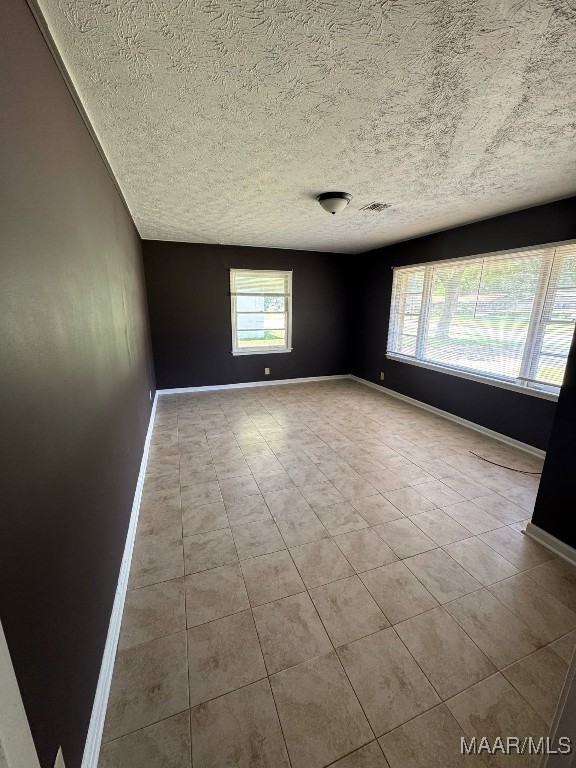 2716 Baldwin Brook Dr, Montgomery, AL 36116 - tiled spare room featuring baseboards and a textured ceiling