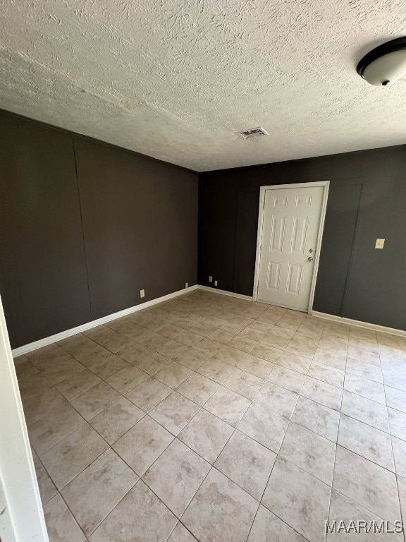 2716 Baldwin Brook Dr, Montgomery, AL 36116 - unfurnished bedroom with a textured ceiling, light tile patterned flooring, and baseboards