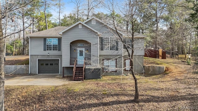 raised ranch featuring a garage and central AC