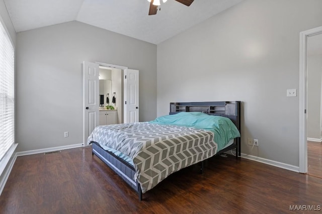 bedroom featuring ceiling fan, dark hardwood / wood-style floors, vaulted ceiling, and multiple windows