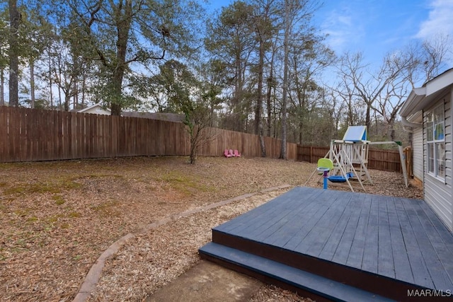 view of yard featuring a playground and a deck