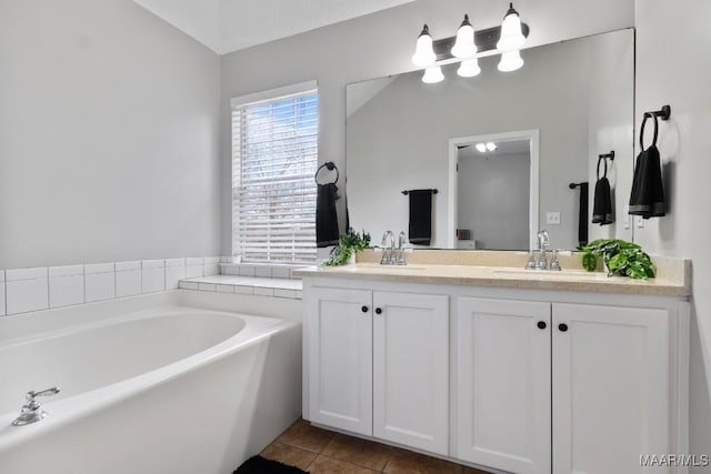 bathroom featuring vanity, tile patterned flooring, and a bathtub