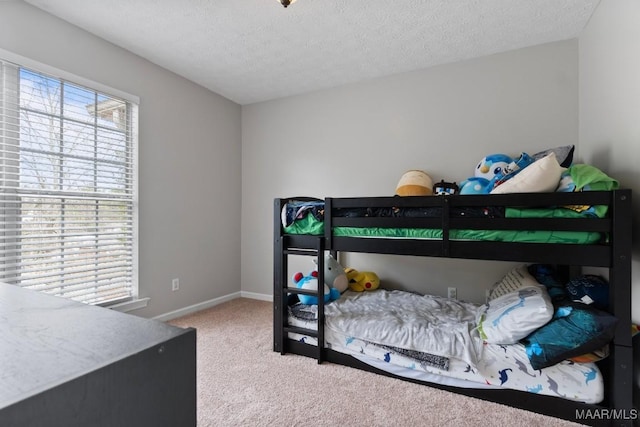 carpeted bedroom featuring a textured ceiling