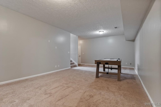 interior space with a textured ceiling and carpet