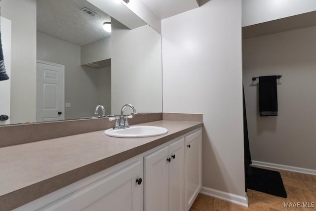 bathroom featuring vanity and a textured ceiling