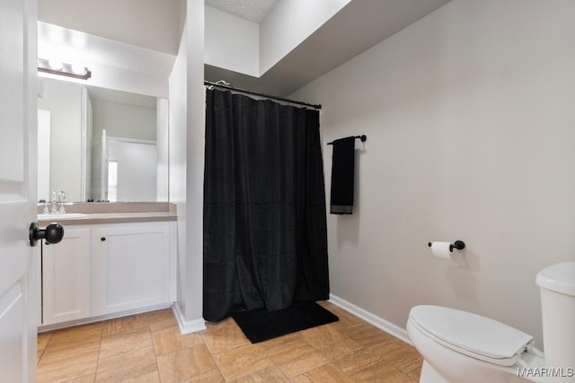 bathroom featuring vanity, a shower with shower curtain, and toilet