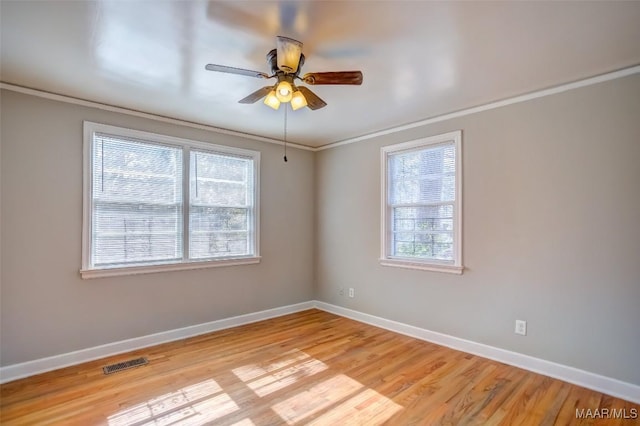 empty room featuring crown molding, ceiling fan, and light wood-type flooring