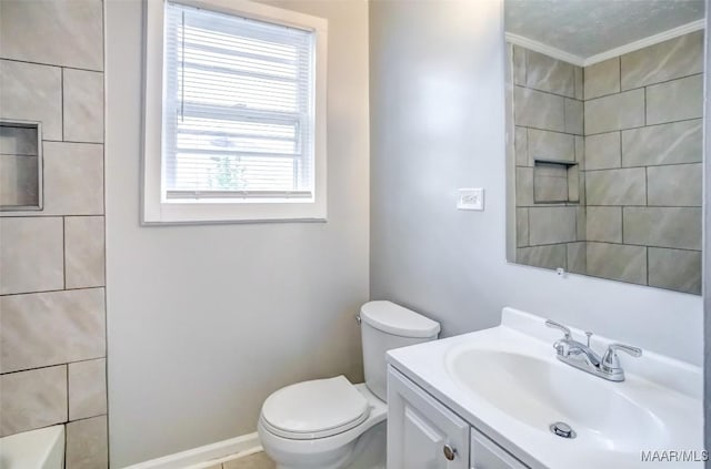 bathroom with vanity, a tub, and toilet