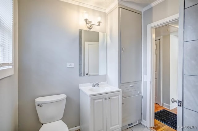 bathroom featuring vanity, ornamental molding, and toilet