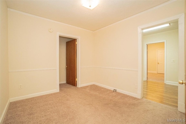 carpeted empty room with ornamental molding