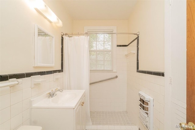 bathroom featuring tile walls, vanity, heating unit, and walk in shower