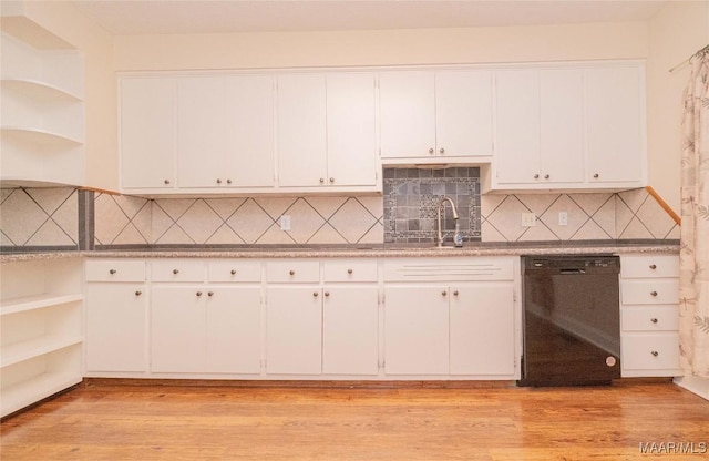 kitchen featuring sink, light hardwood / wood-style flooring, white cabinetry, black dishwasher, and decorative backsplash