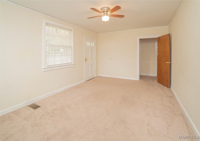 carpeted spare room featuring ceiling fan