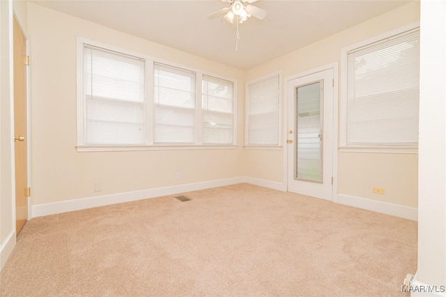 carpeted empty room featuring ceiling fan