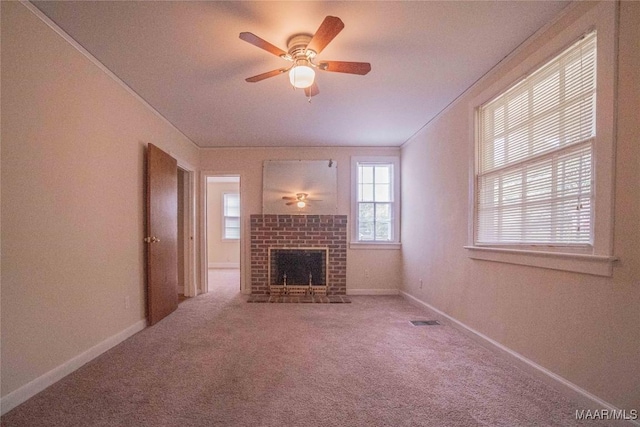 unfurnished living room featuring ceiling fan, carpet flooring, and a fireplace